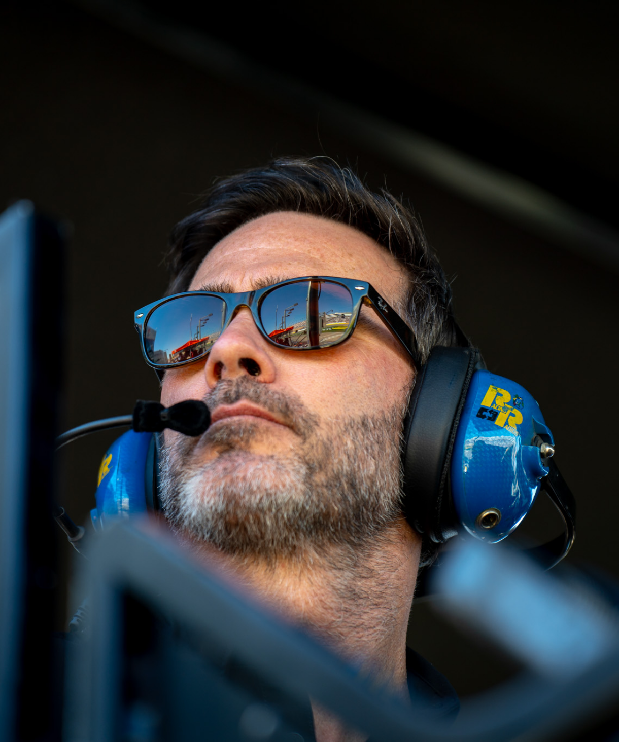 Jimmie Johnson with a headset in the pit box