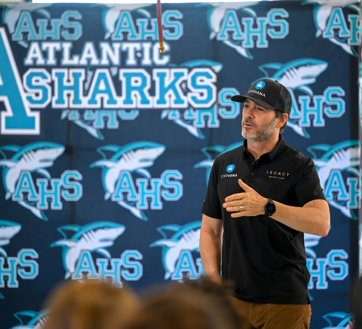 Jimmie Johnson speaking at a high school for the Jimmie Johnson Foundation